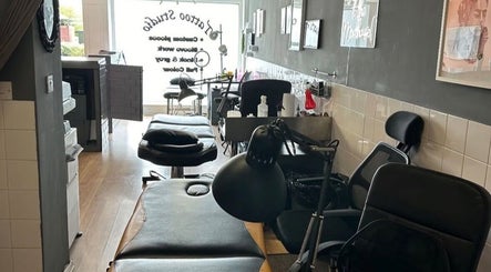Interior of Mind Over Matter Tattoo Studio in Hazel Grove, England, featuring tattoo stations and sleek decor.