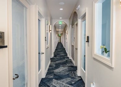 Chic hallway at Two Chairs Salon, Boca Raton, Florida, US showcasing modern design and elegant lighting.