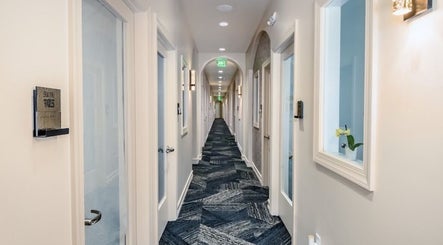 Chic hallway at Two Chairs Salon, Boca Raton, Florida, US showcasing modern design and elegant lighting.
