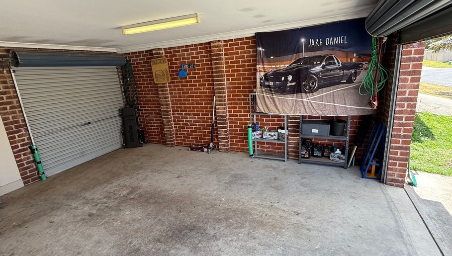 JD Automotive Detailing garage interior in Springdale Heights, New South Wales, AU with clean organized setup.