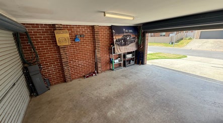 Spacious garage of JD Automotive Detailing at Springdale Heights, New South Wales, AU, showcasing organized tools.
