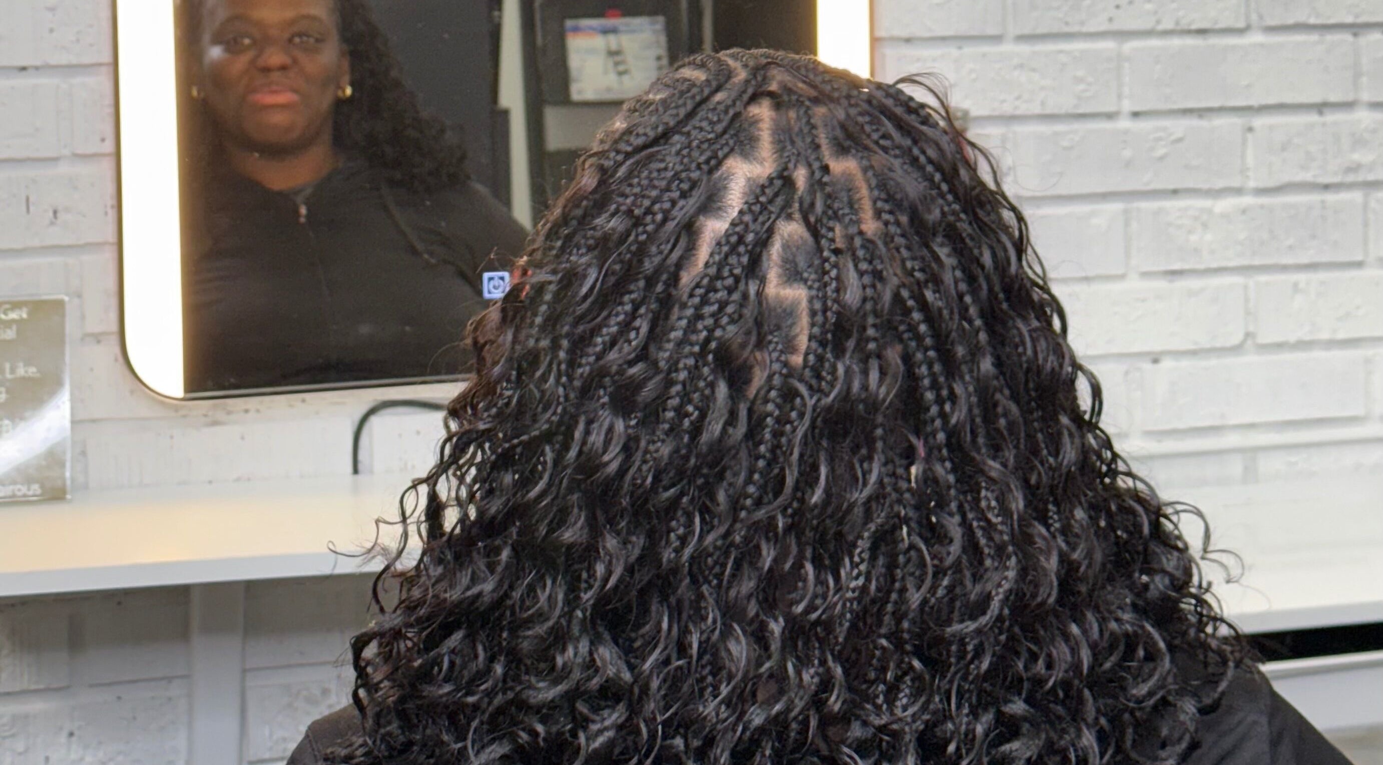 Intricate braided hairstyle at Loft A58, Toronto, Ontario, CA with stylist reflection in mirror.