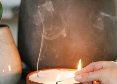 Lit candle in Stellenbosch Wellness Salon, Stellenbosch, Western Cape, ZA offers a calming ambiance.