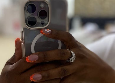 Colorful nail art at Gifted Handz, Pretoria, Gauteng, ZA, holding a phone with stylish design.