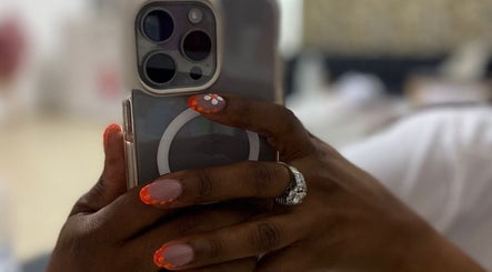 Colorful nail art at Gifted Handz, Pretoria, Gauteng, ZA, holding a phone with stylish design.