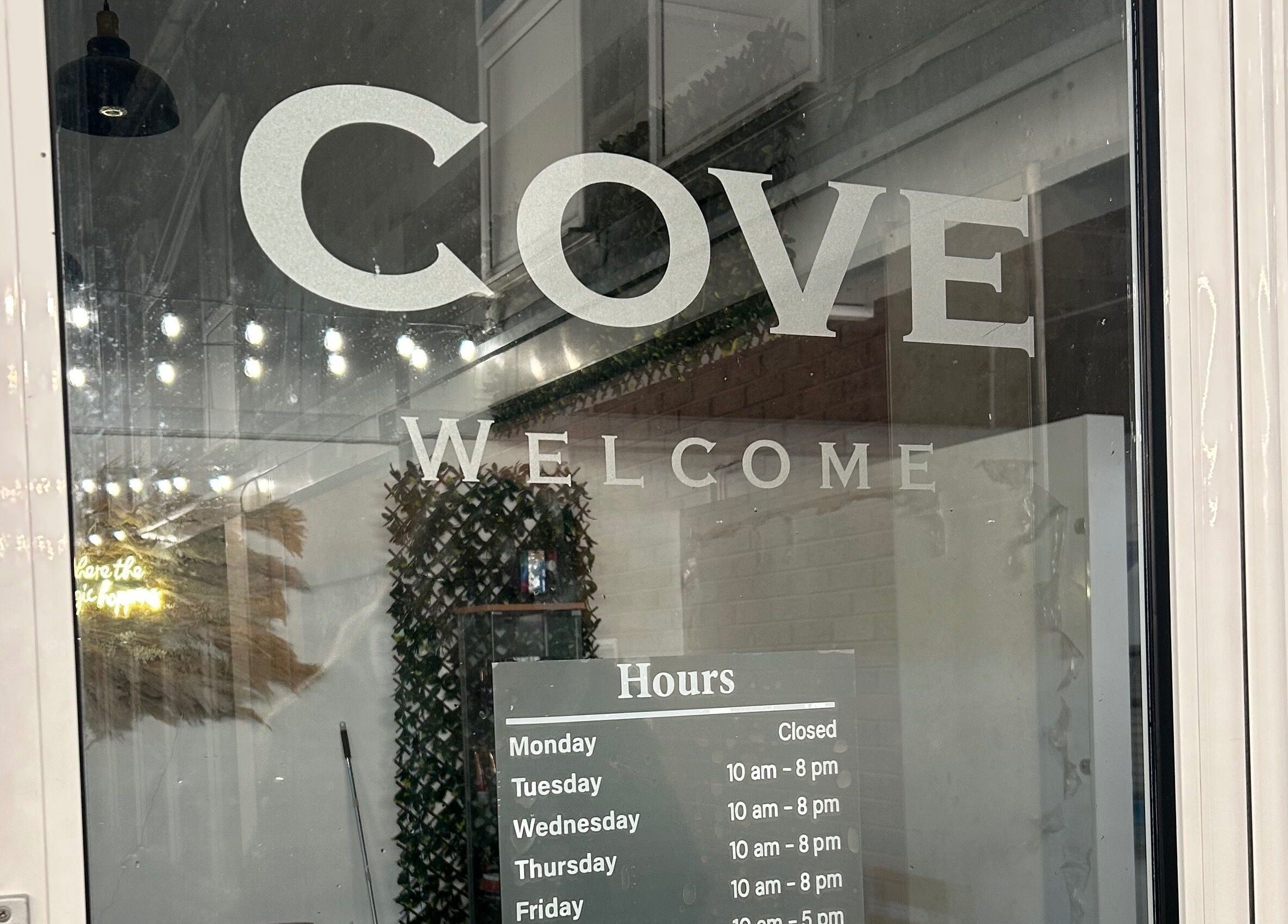 Cove Tanning Studio entrance with welcome sign and hours in Droitwich Spa, England, GB.