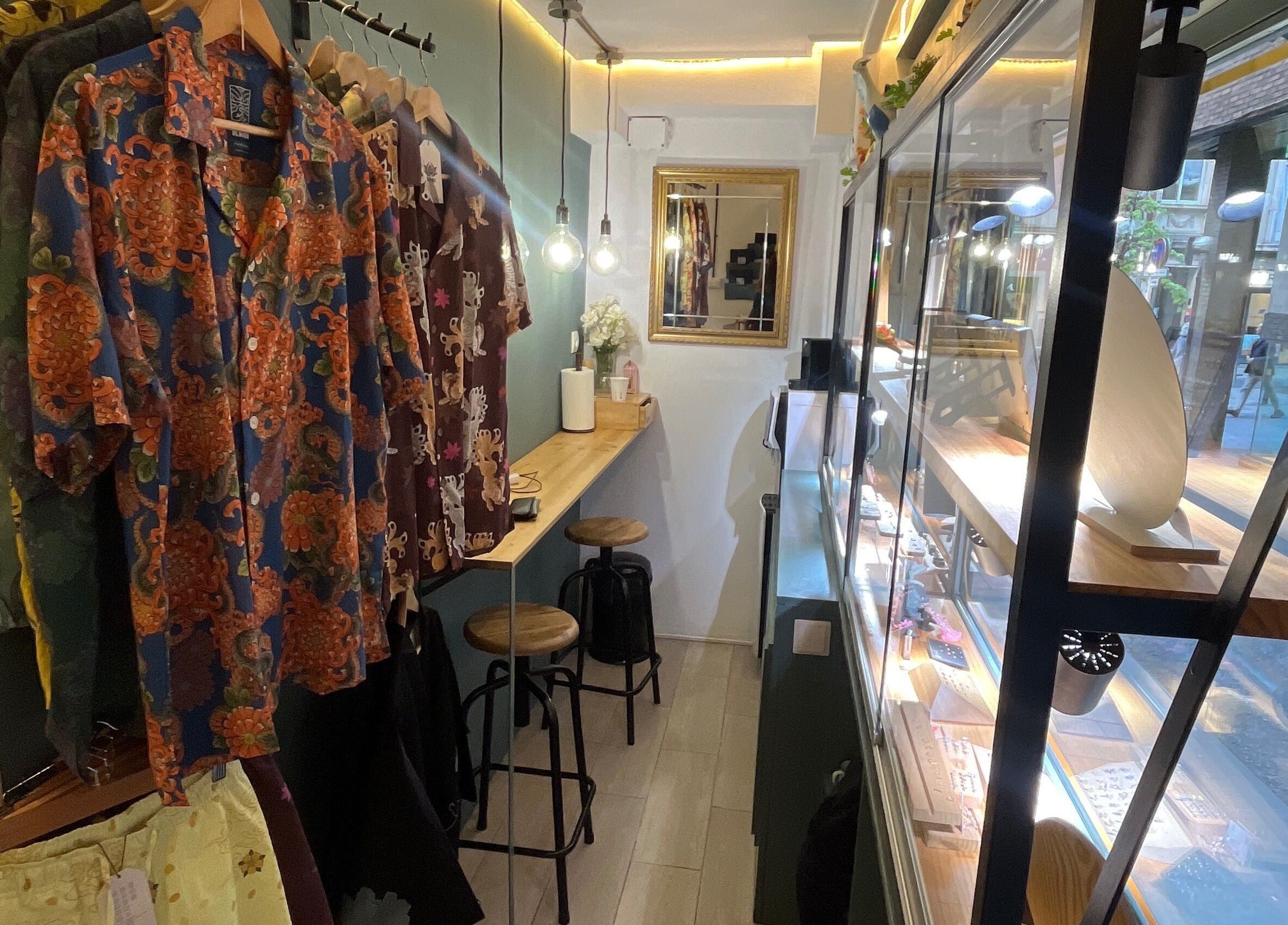 Colorful shirts displayed in Nia ochoa, Barcelona, Barvelona, ES. Cozy seating and bright showcase add charm.