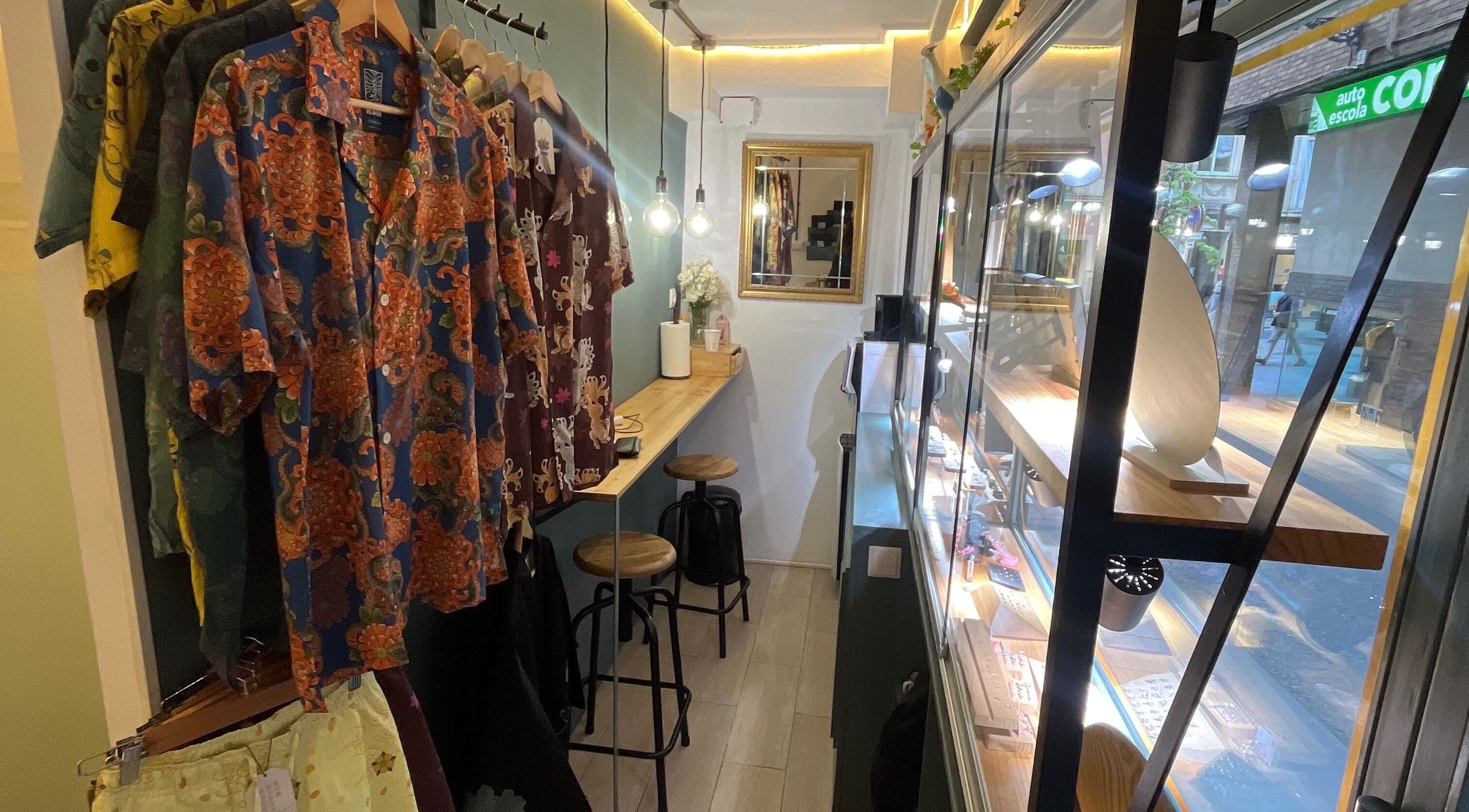 Colorful shirts displayed in Nia ochoa, Barcelona, Barvelona, ES. Cozy seating and bright showcase add charm.