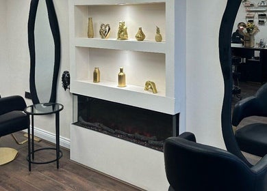 Chic salon interior at Sassy P Beauty & Co, Sale, England, featuring modern decor and plush seating.