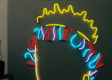 Vibrant neon sign at DTRHair, Newcastle upon Tyne, England, GB, showcasing colorful abstract patterns.