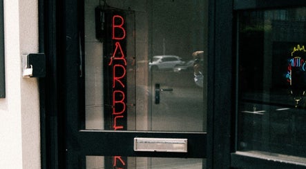 Neon barber sign at DTRHair in Newcastle upon Tyne, England, GB, inviting customers inside.