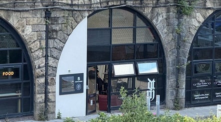 DTRHair entrance with stone arch facade in Newcastle upon Tyne, England, GB.