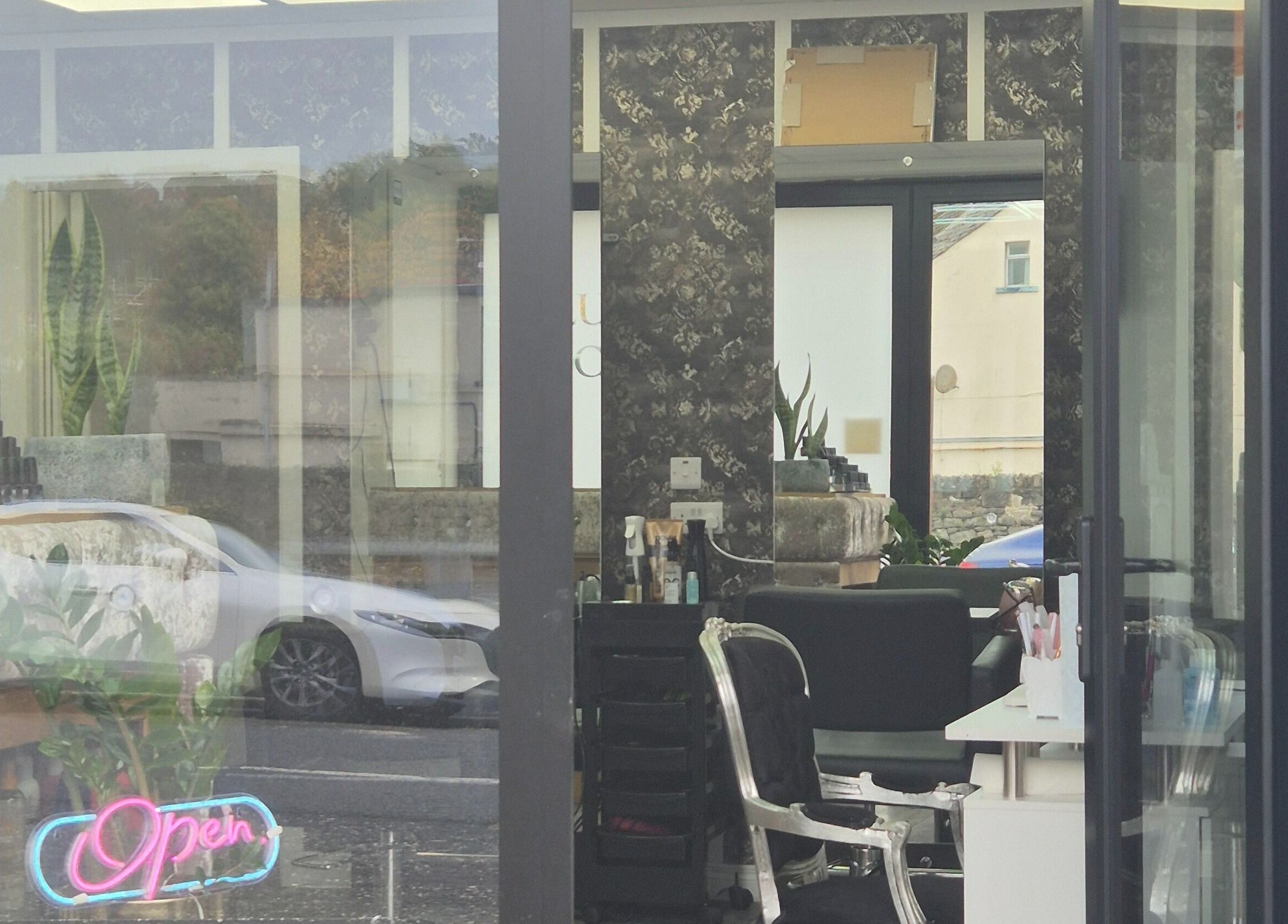 View of D'Lux Salon -Newry, featuring stylish interior and neon 'Open' sign, Newry, Northern Ireland, GB.