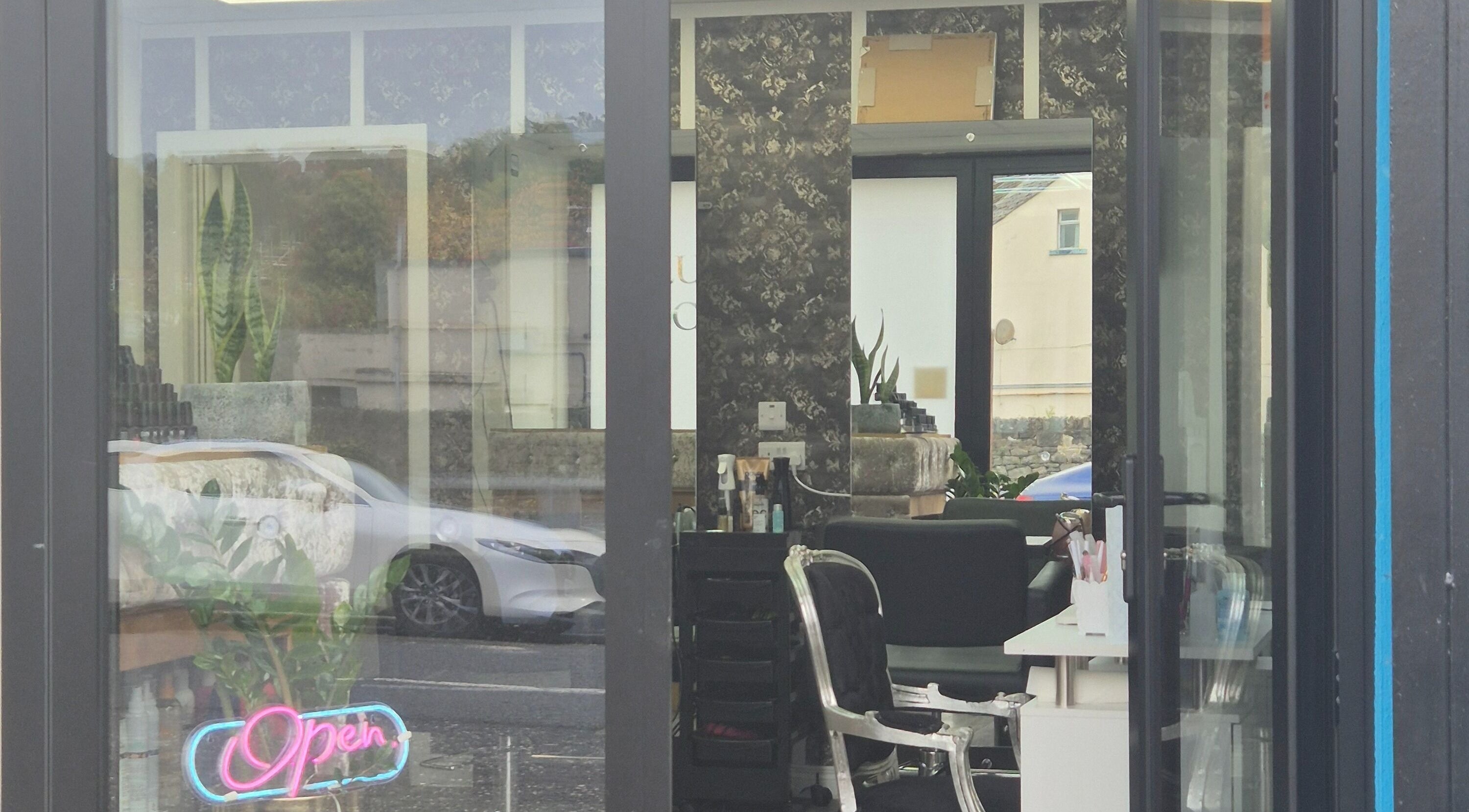 View of D'Lux Salon -Newry, featuring stylish interior and neon 'Open' sign, Newry, Northern Ireland, GB.