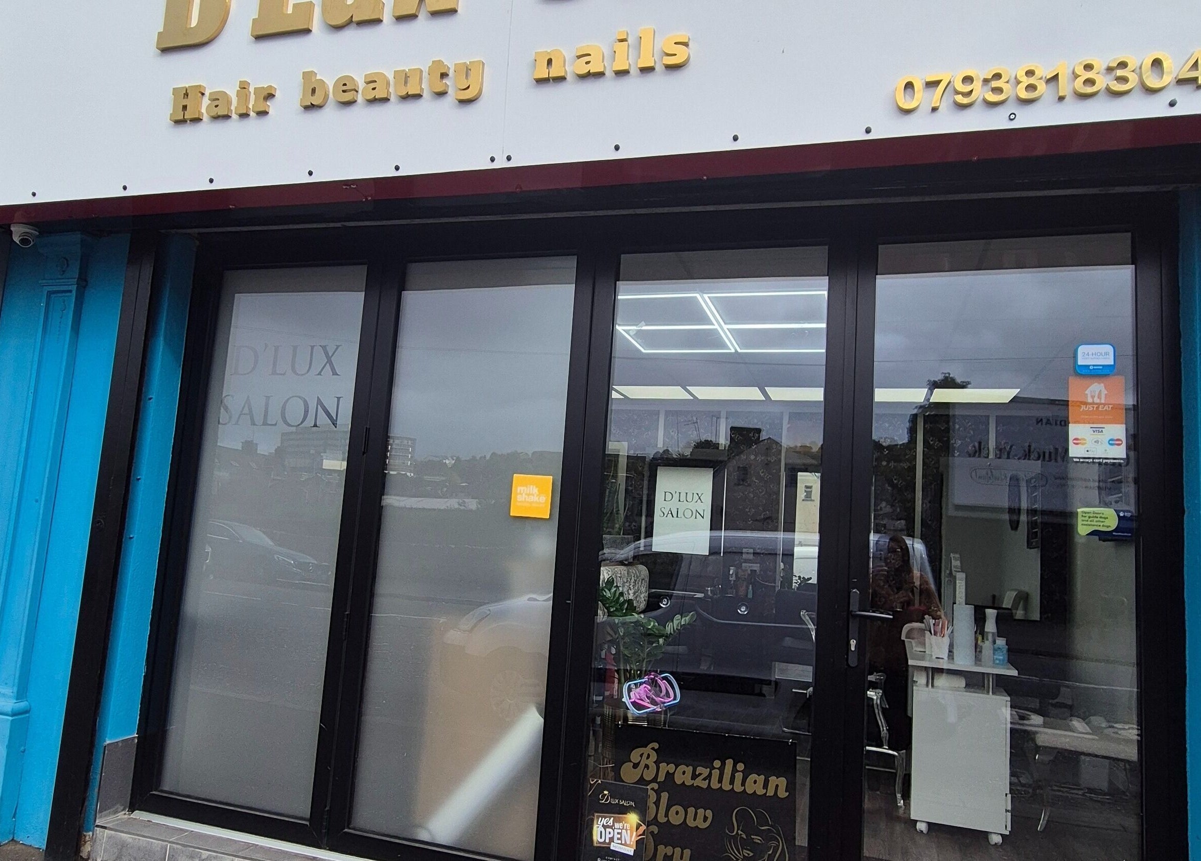 Front view of D'Lux Salon -Newry in Newry, Northern Ireland, GB, showcasing the entrance with glass doors.