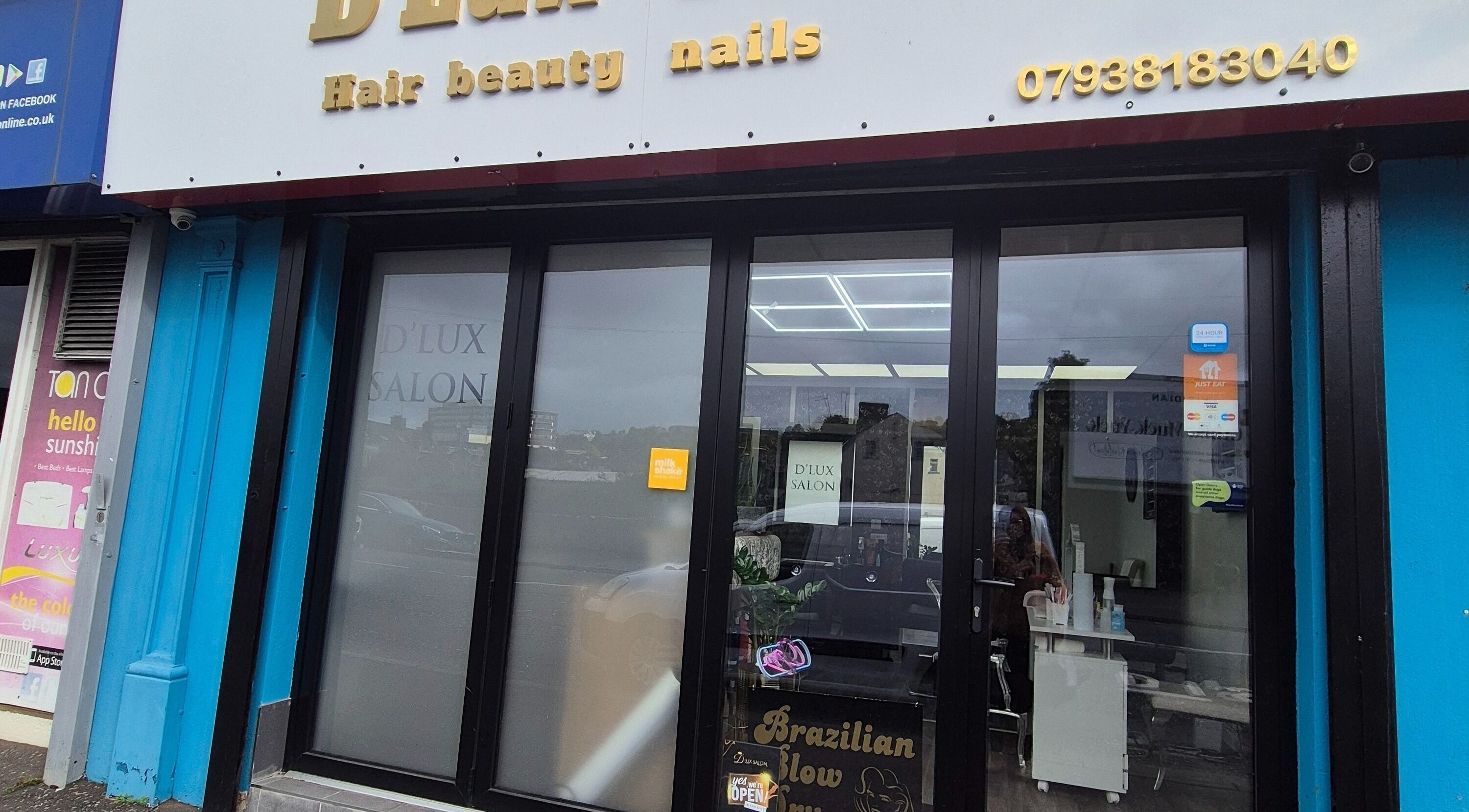 Front view of D'Lux Salon -Newry in Newry, Northern Ireland, GB, showcasing the entrance with glass doors.