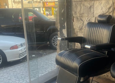 Barber chair at Qusai, a salon in عمّان, محافظة العاصمة, JO, offering exceptional grooming services.