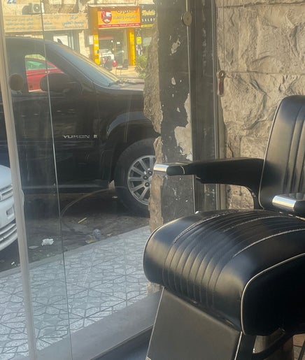 Barber chair at Qusai, a salon in عمّان, محافظة العاصمة, JO, offering exceptional grooming services.