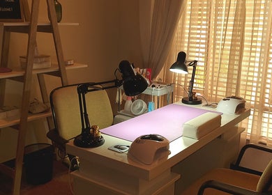 Tranquil nail desk setup at Nails by Tazmé, Roodepoort, Gauteng, ZA with soft lighting and stylish decor.