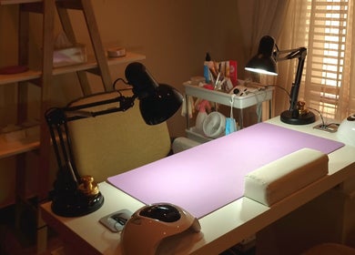 Elegant nail workspace at Nails by Tazmé, Roodepoort, Gauteng, ZA showcasing tools and ambient lighting.
