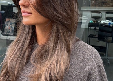 Stylish brunette hairstyle at Erdem Hair London, London, England, GB salon window view.