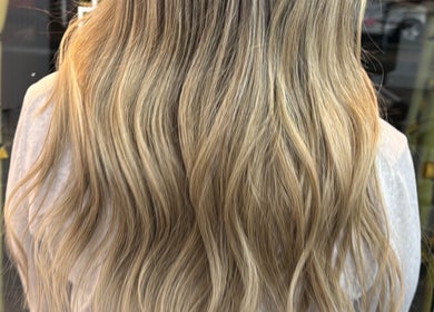 Blonde wavy hairstyle at Erdem Hair London, showing luxurious hair in London, England, GB.