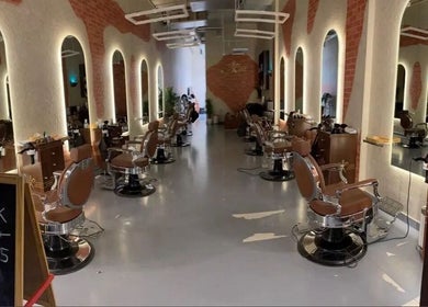 Modern interior of Sharp Look in Riyadh, Riyadh Province, SA, featuring stylish barber chairs and elegant lighting.