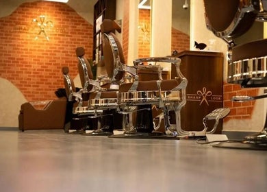 Modern styling chairs at Sharp Look, Riyadh, Riyadh Province, SA with brick walls in the background.