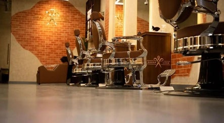 Elegant barber chairs at شارب لوك Sharp Look, Riyadh, Riyadh Province, SA, showcasing luxury and style.