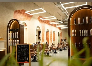 Interior of شارب لوك Sharp Look salon in Riyadh, showcasing modern chairs and elegant product displays.