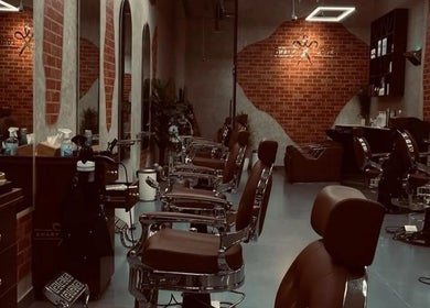 Interior of شارب لوك Sharp Look, a stylish barbershop in Riyadh, Riyadh Province, SA with chic chairs and decor.