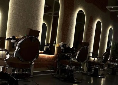 Stylish salon interior with modern chairs and backlit mirrors at شارب لوك Sharp Look, Riyadh, Riyadh Province, SA.