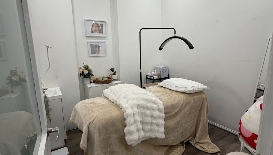 Relaxing treatment room at The Beauty Atelier, Melbourne, Victoria, AU with plush bed and serene decor.