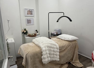 Relaxing treatment room at The Beauty Atelier, Melbourne, Victoria, AU with plush bed and serene decor.