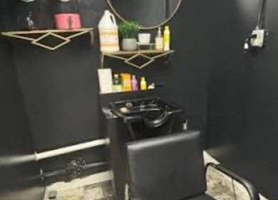Glamour and Glitter by Jessica salon wash station with sleek black decor in Greenwood, South Carolina, US.