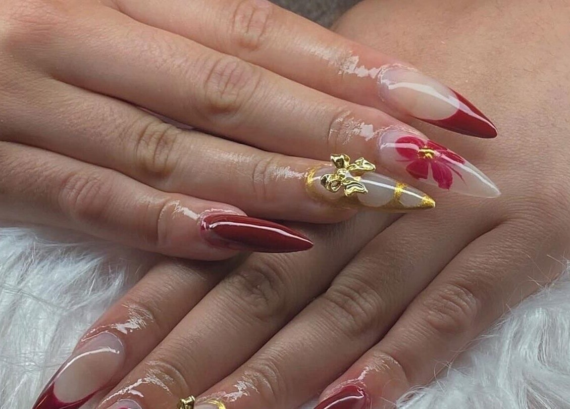 Stunning nail art with red and gold accents at ClawzbyLau, Canelones, Departamento De Canelones, UY.
