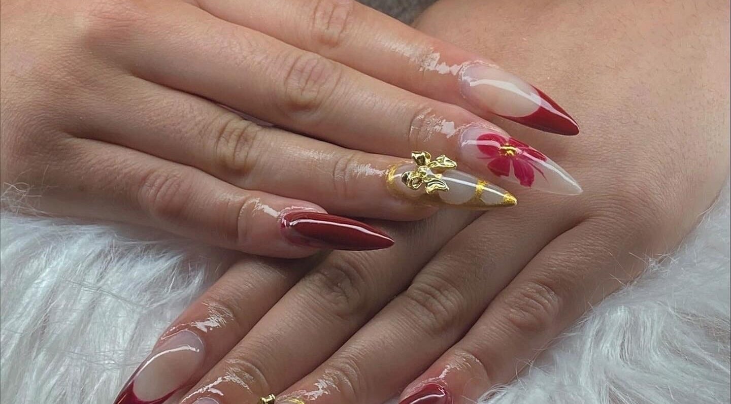 Stunning nail art with red and gold accents at ClawzbyLau, Canelones, Departamento De Canelones, UY.