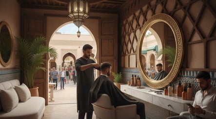 Inside Fitrah Men Center, Marrakech, where a barber styles a client's hair in a sophisticated setting.