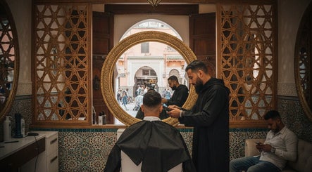 A stylist at Fitrah Men Center in Marrakech, Marrakech-safi, MA, provides a haircut in a beautifully decorated salon.