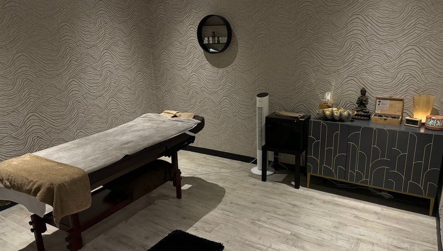 Serene treatment room at Touch of Orient, Reading, England, GB with massage table and elegant decor.