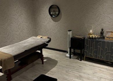Serene treatment room at Touch of Orient, Reading, England, GB with massage table and elegant decor.