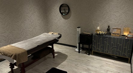 Serene treatment room at Touch of Orient, Reading, England, GB with massage table and elegant decor.