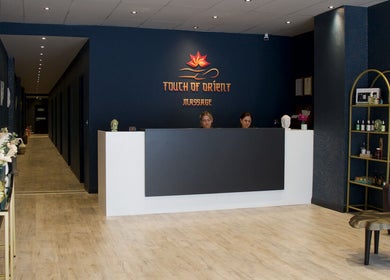 Reception area of Touch of Orient in Reading, England, GB with elegant decor and staff at the desk.
