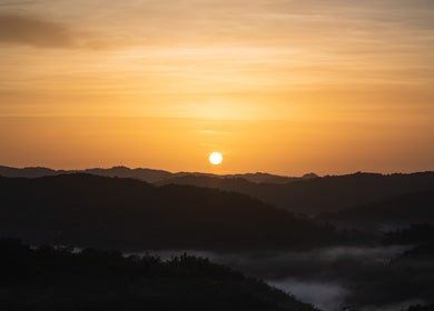 Breathtaking sunrise over hills near icaptureja, Reading, St. James Parish, JM, highlighting natural beauty.