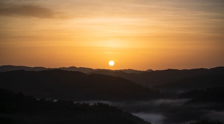 Breathtaking sunrise over hills near icaptureja, Reading, St. James Parish, JM, highlighting natural beauty.