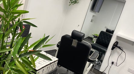 Interior view of Charles Maclean Elite salon showing a stylish chair and mirror in Bridgwater, England, GB.