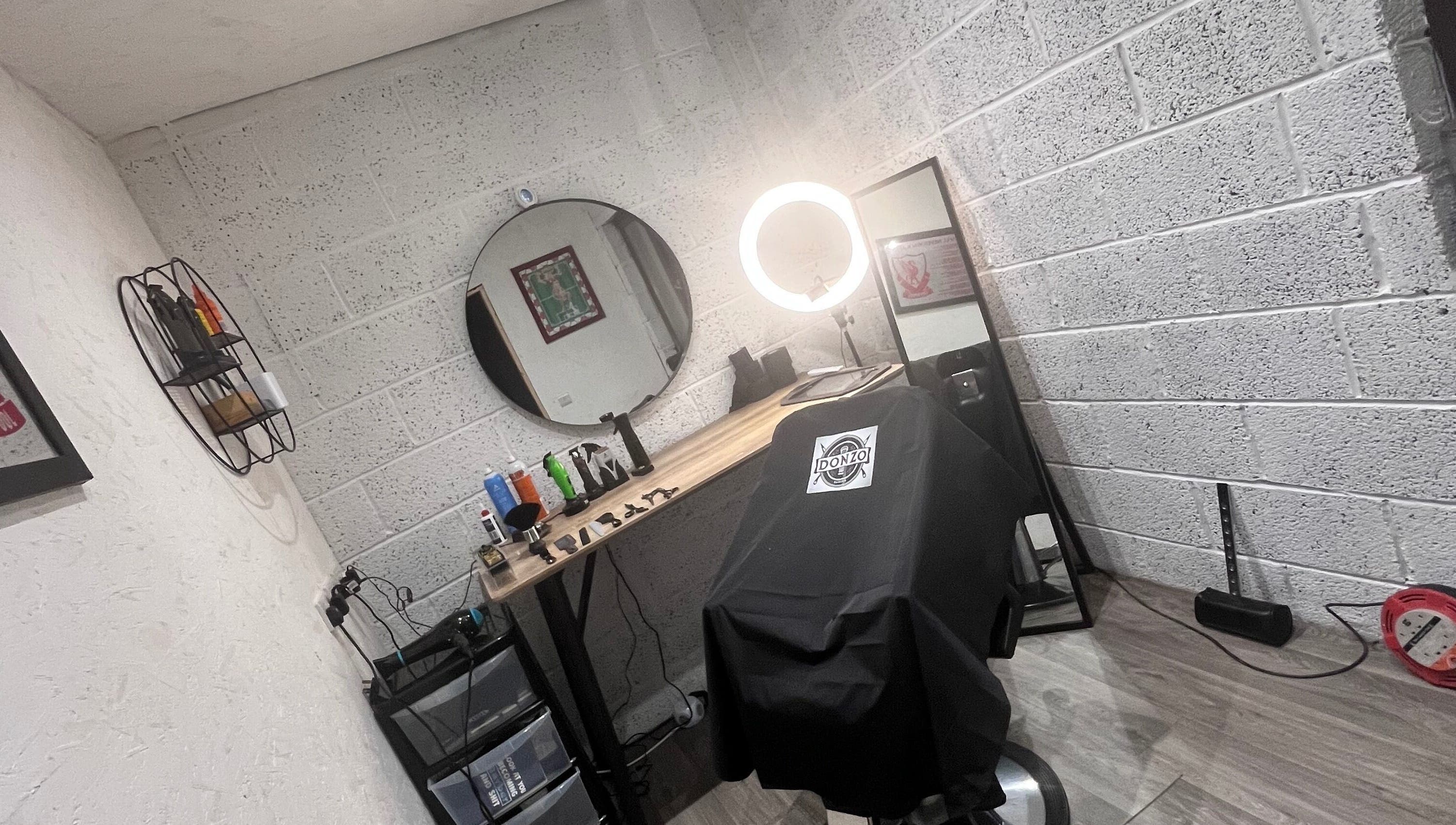 Modern barber chair setup at Donzos_cuts, Pembroke, Wales, GB showcasing professional styling tools.