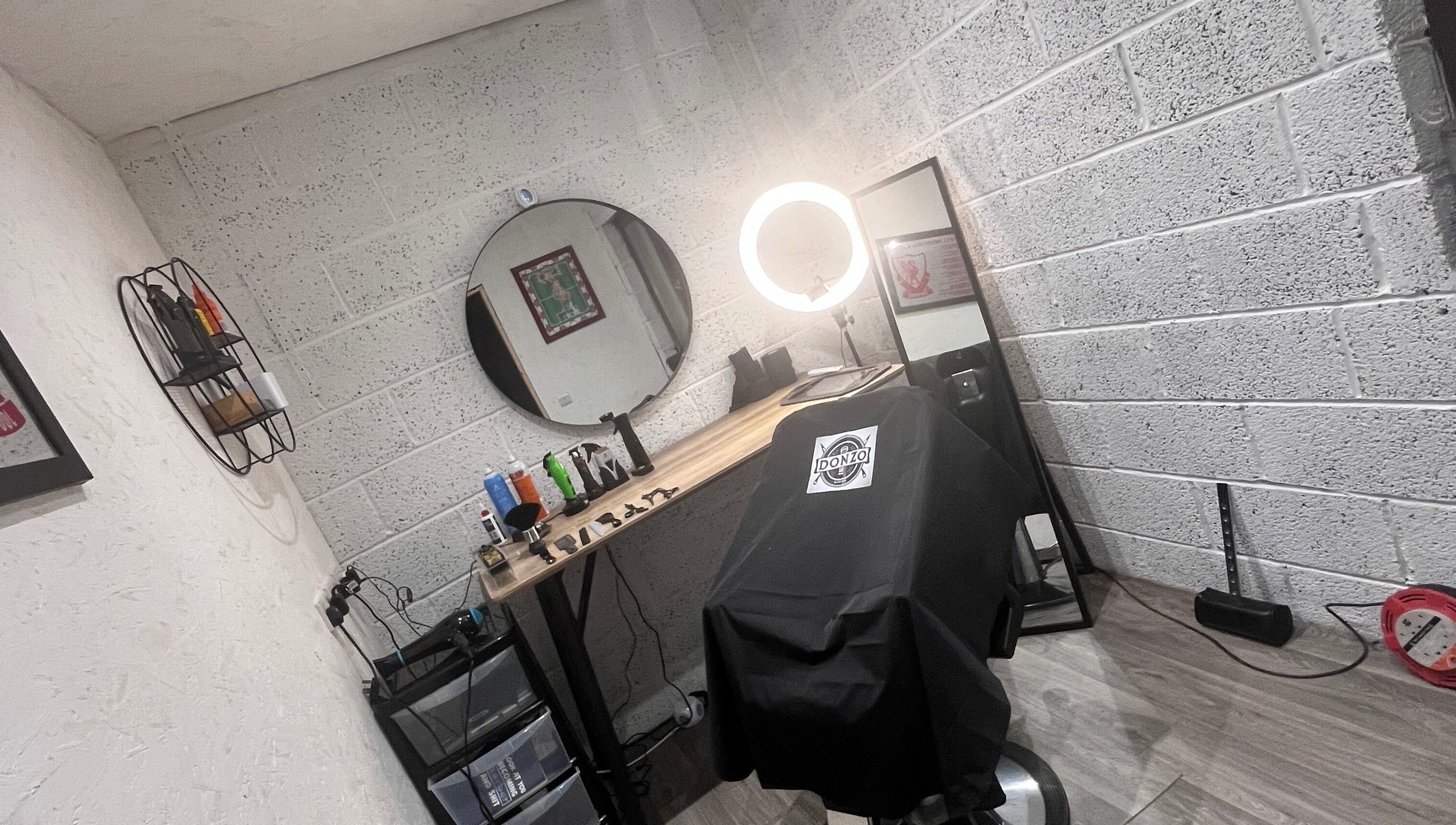 Modern barber chair setup at Donzos_cuts, Pembroke, Wales, GB showcasing professional styling tools.