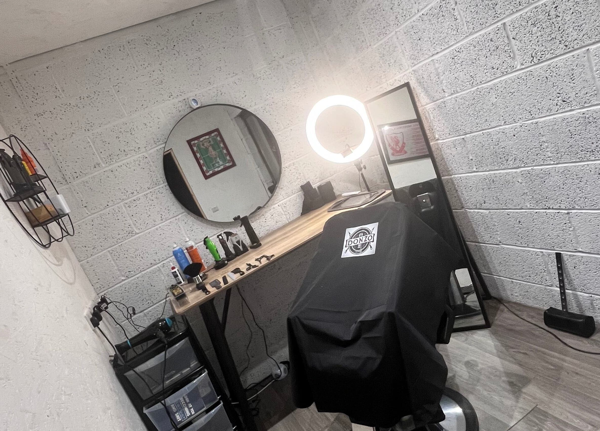 Modern barber chair setup at Donzos_cuts, Pembroke, Wales, GB showcasing professional styling tools.