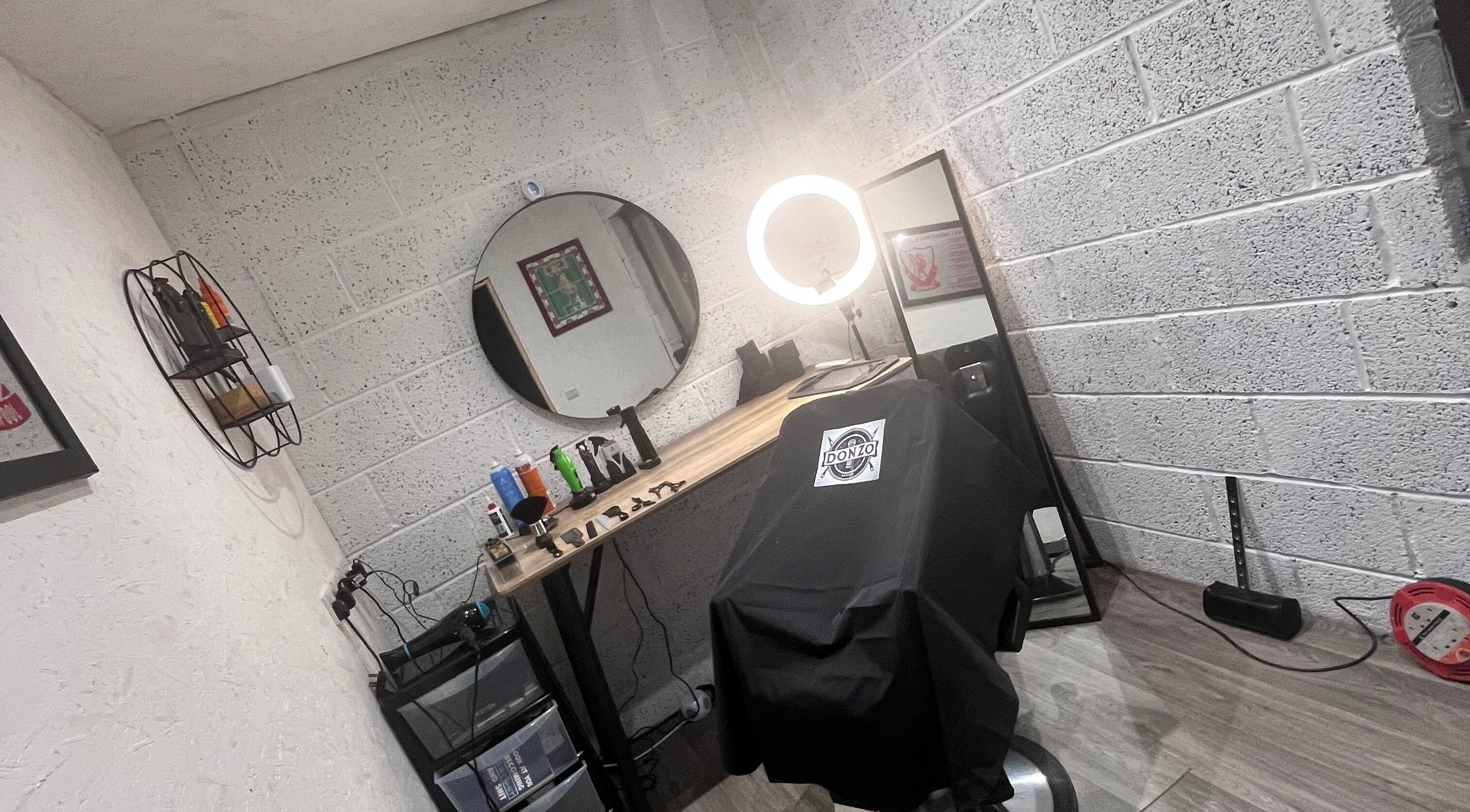 Modern barber chair setup at Donzos_cuts, Pembroke, Wales, GB showcasing professional styling tools.